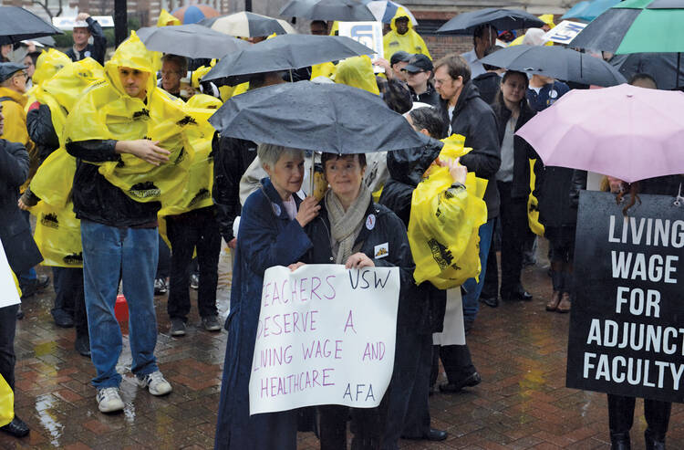 LABOR LESSON. Rae O’Hair, left, a Duquesne University alumna, and her friend Daniele Orosz rally for unionizing adjunct faculty in December 2013.