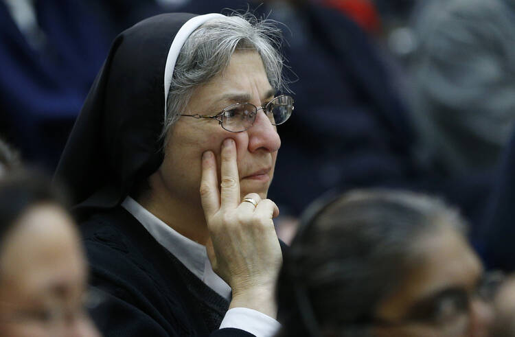 A sister listens during Vatican press conference for release of final report of Vatican-ordered investigation of U.S. communities of women religious, Dec. 16 (CNS Photo, Paul Haring).