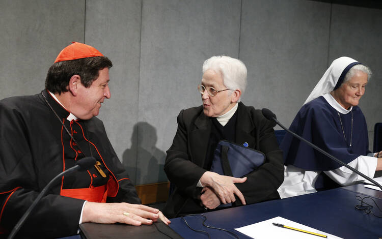 Cardinal Braz de Aviz speaks with Sister Holland at conclusion of Vatican press conference for release of final report of Vatican-ordered investigation of U.S. communities of women religious, Dec. 16 (Paul Haring, CNS photo).