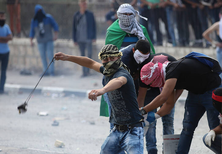 TENSIONS MOUNT. Palestinian protesters clash with Israeli soldiers in Bethlehem, West Bank, on Oct. 6.