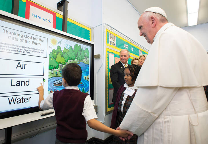 TASKMASTER. Pope Francis gets a lesson on the environment in East Harlem.