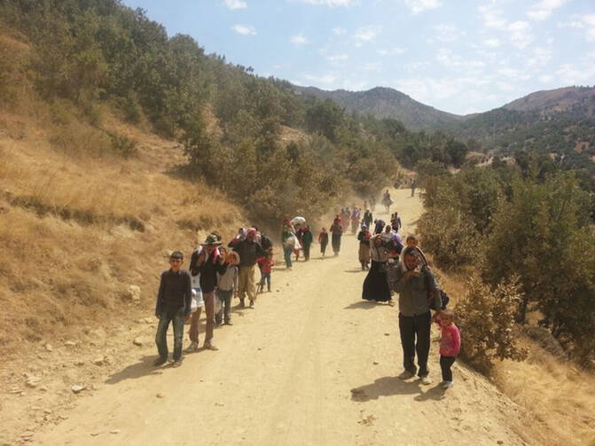 YAZIDI EXODUS. These refugees escaping from Iraq into Turkey were joined in September by waves of Syrian Kurds in flight from ISIS.