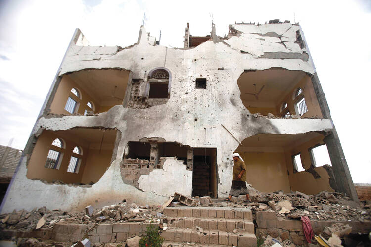 The Aftermath: A tribesman walks past a building damaged last year by a U.S. drone strike in southeastern Yemen