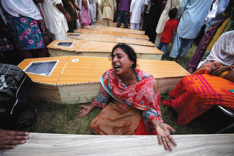 Mourning in Pakistan: A Christian woman mourns her brother, killed along with 80 others in an attack at All Saints Church in Peshawar, Pakistan, in 2013.