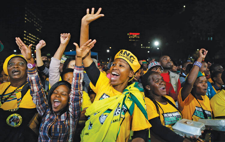 VICTORIOUS. African National Congress supporters celebrate the election results in Johannesburg on May 10.
