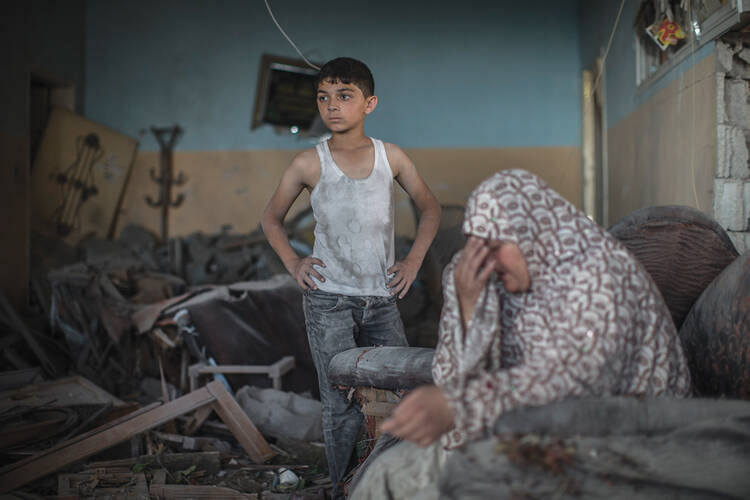 COLLATERAL DAMAGE. A Palestinian woman weeps on July 17 in what remains of her Gaza City home. the death toll in Gaza exceeded 510, mostly noncombatants, on July 21.