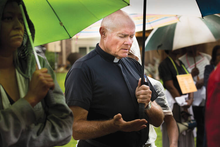 Father Robert "Rosy" Rosebrough leads a prayer service last summer.