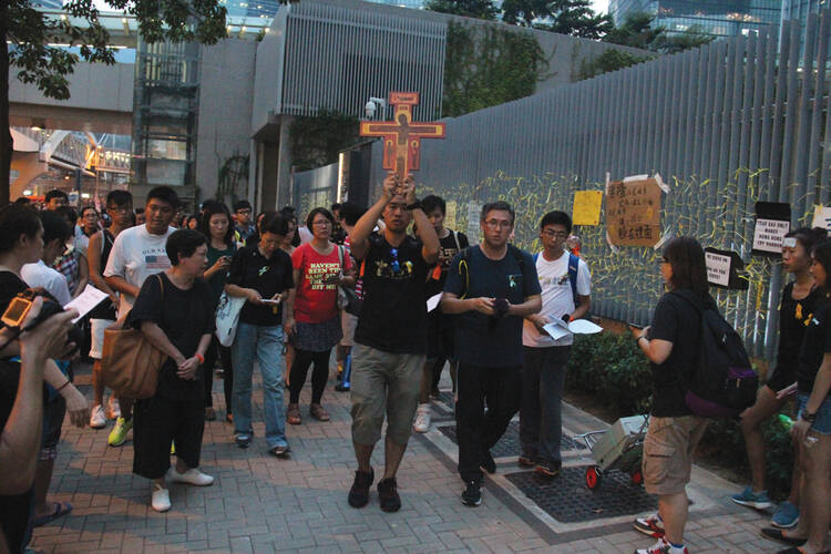 Does Democracy Have a Prayer? Catholic youth join demonstrators outside a government office in Hong Kong on Sept. 30.