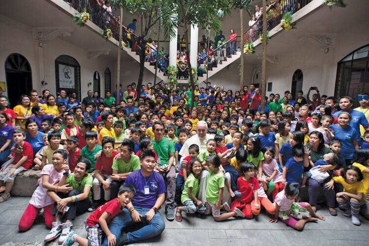 AMONG SCHOOL CHILDREN. Pope Francis made time in Manila on Jan. 16 to visit with the young residents of a home for former street children.