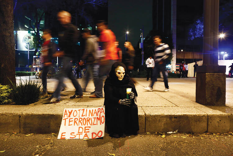 NOCHE DE LOS MUERTOS. Demonstrators demanded justice for 43 missing students in Mexico City on Nov. 8. The sign reads “Ayotzinapa, state terrorism” 