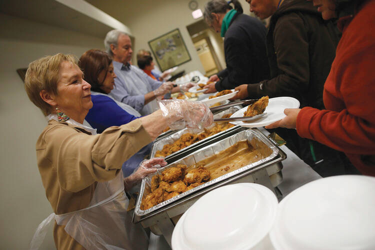 Fighting hunger. Volunteers serving up a warm meal through a Catholic Charities USA emergency assistance program last November in Chicago.