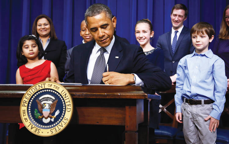 President Barack Obama signs executive orders on Jan. 16.