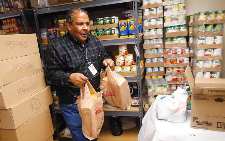 New Costumers: A volunteer prepares packages at a Catholic Charities food pantry in Chicago.