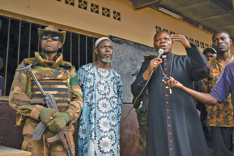 Peace Offensive: Archbishop Dieudonné Nzapalainga and Imam Omar Kobine Layama tour a church on the outskirts of Bangui in mid-December in an effort to promote tolerance and reconciliation.