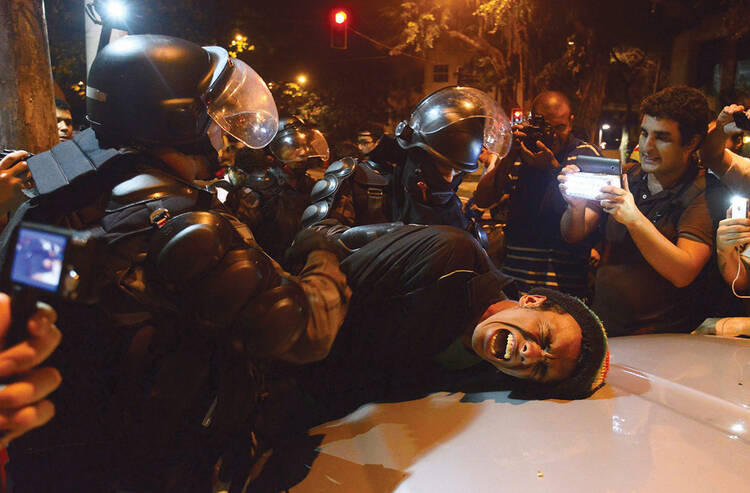 Soccer Wars: Riot police tangle with Brazilians protesting excessive spending on the 2014 FIFA World cup in July 2013.