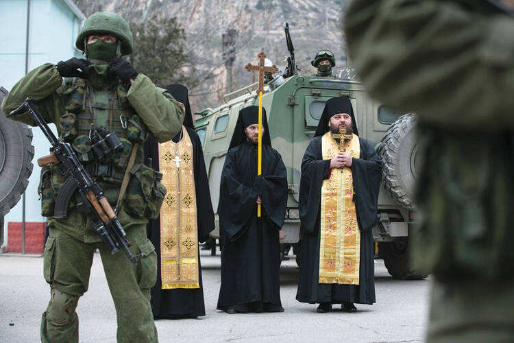 Call to Arms? Orthodox clergymen pray outside a border guard post in Ukraine’s Crimean region on March 1.