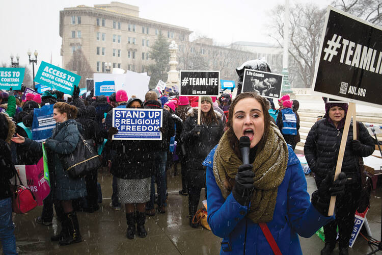 ORAL ARGUMENTS. Protesters clash outside the Supreme Court on March 25.