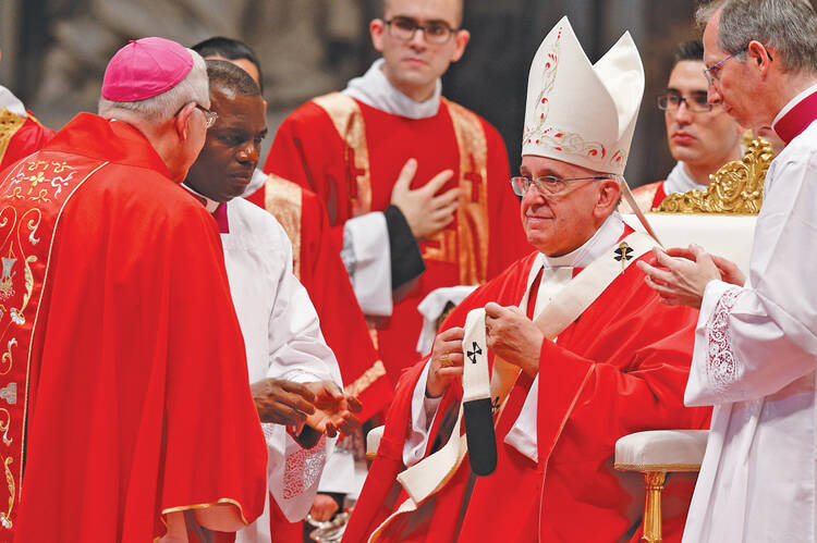 THE CHURCH IS IN THE BISHOP. Pope Francis presents a pallium in St. Peter’s Basilica last June to Archbishop Leonard P. Blair of Hartford, Conn.