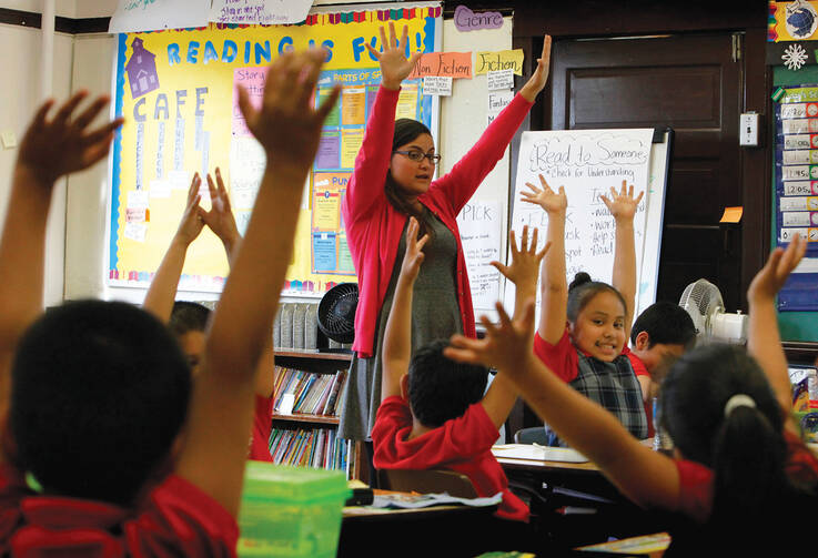 MAKING THE GRADE. Maria Rodriguez with her third-grade students at Maternity of the Blessed Virgin Mary School in Chicago