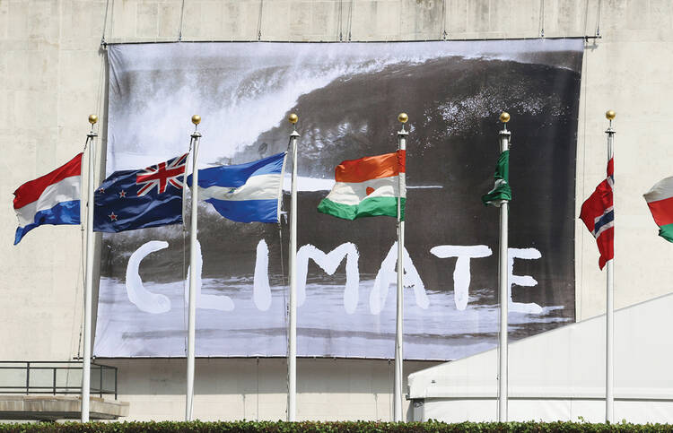 CLIMATE CHECK. A banner waving from the U.N. General Assembly building in New York on June 30 defines the nature of the debate inside.