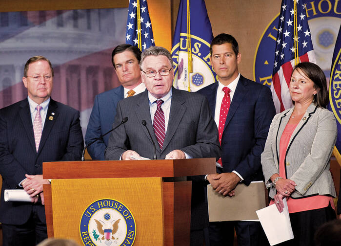 Representative Chris Smith, flanked by other members of the House, urges Congress to look into Planned Parenthood policies.