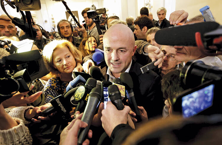 Italian journalist Gianluigi Nuzzi is surrounded by the media after a Nov. 4 news conference for his new book "Merchants in the Temple: Inside Pope Francis' Secret Battle Against Corruption in the Vatican." (CNS photo/Yara Nardi, Reuters)