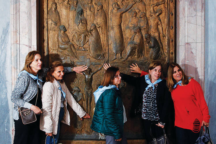 Door Stop. Visitors touch the Holy Door at the Basilica of St. Paul Outside the Walls on Nov. 19. 