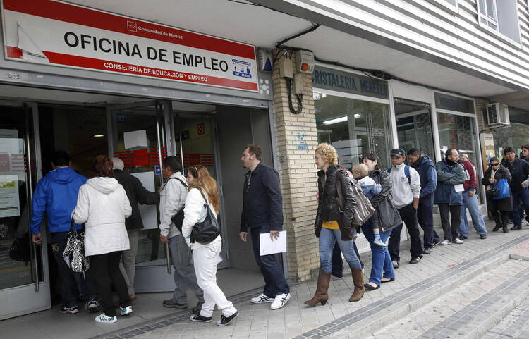 PEOPLE STAND IN LINE AT GOVERNMENT EMPLOYMENT OFFICE IN SPAIN