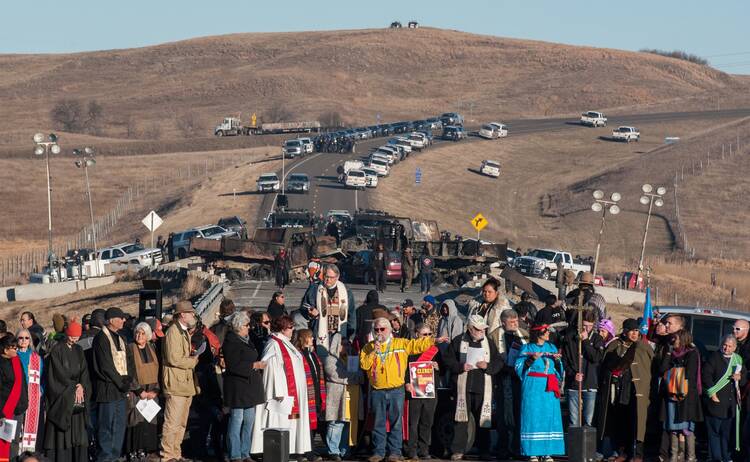 Clergy of many faiths from across the United States participate in a prayer circle on Nov. 3, 2016, in front of a bridge in Standing Rock, N.D., where demonstrators confront police during a protest of the Dakota Access pipeline. (CNS photo/Stephanie Keith, Reuters)