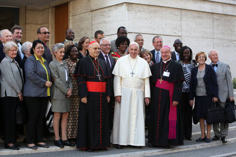 Pope Francis poses with auditors of the extraordinary Synod of Bishops on the family as he arrives for the afternoon session at the Vatican, Oct. 10 (CNS Photo). 