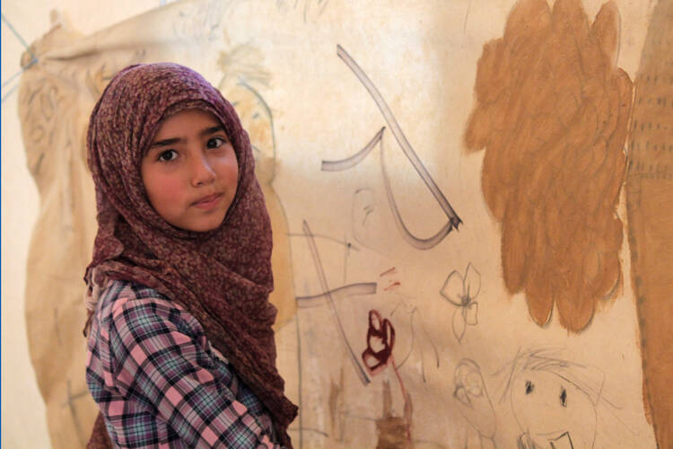 Desert refuge. A Syrian girl in Jordan's Zaatari refugee camp girl paints her vision of a perfect place to live.