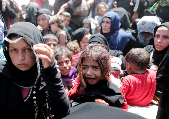 A young Syrian refugee girl cries after arriving at the Turkish-border city of Sanliurfa on June 10. (CNS photo/Sedat Suna, EPA)