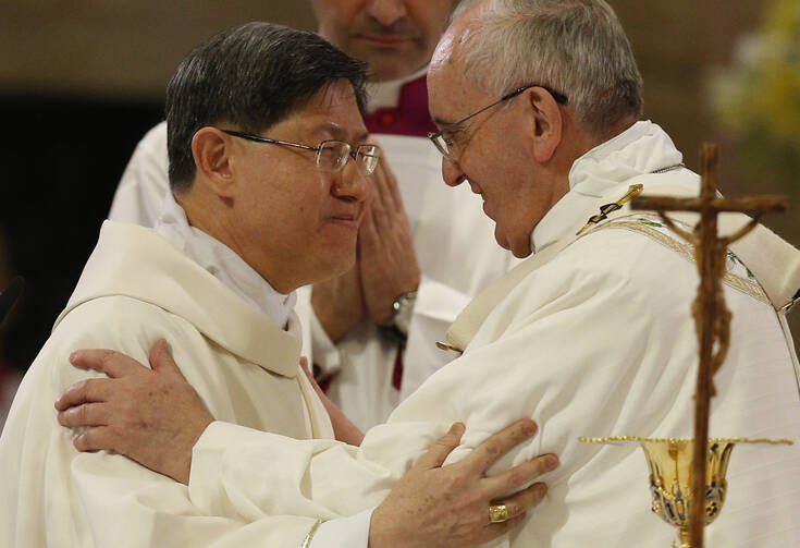 Pope Francis greets Cardinal Luis Antonio Tagle of Manila, Philippines, at the sign of peace while celebrating Mass at the city's Cathedral of the Immaculate Conception on Jan. 16. (CNS photo/Paul Haring)