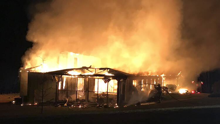 Fire destroys the main offices of the Highlander Research and Education Center in New Market, Tenn., on March 29, 2019. The center is a social justice center that trained the Rev. Martin Luther King Jr. and other civil rights leaders. Representatives of the center said Tuesday, April 2, 2019, that a white power symbol was also found spray painted on the parking lot near the building. (Sammy Solomon/New Market Fire and Rescue Team via AP)