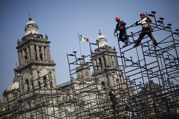 Workers prepare the grandstands outside Metropolitan Cathedral on Feb. 5, 2016, in preparation for the upcoming visit of Pope Francis to Mexico City. Photo courtesy of REUTERS/Edgard Garrido