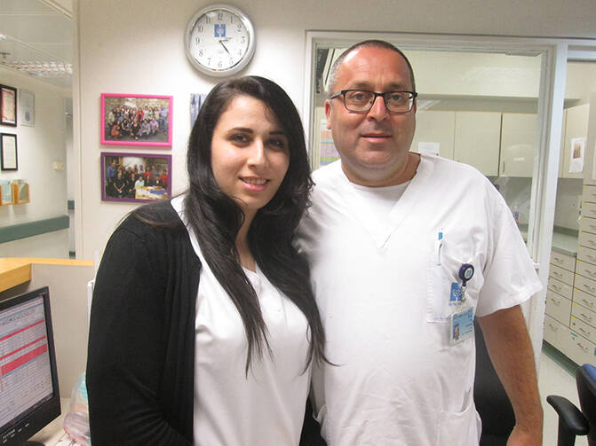 Rula Badarna, left, and Stuart Levy, both nurses at Hadassah Medical Center in Jerusalem, say their ward is a model of religious coexistence and friendship. RNS photo by Michele Chabin
