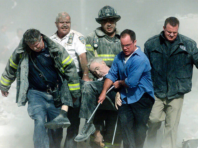 Rescue workers carry fatally injured New York City Fire Department chaplain, the Rev. Mychal Judge, from the wreckage of the World Trade Center in New York City on Sept. 11, 2001. Photo courtesy of REUTERS/Shannon Stapleton