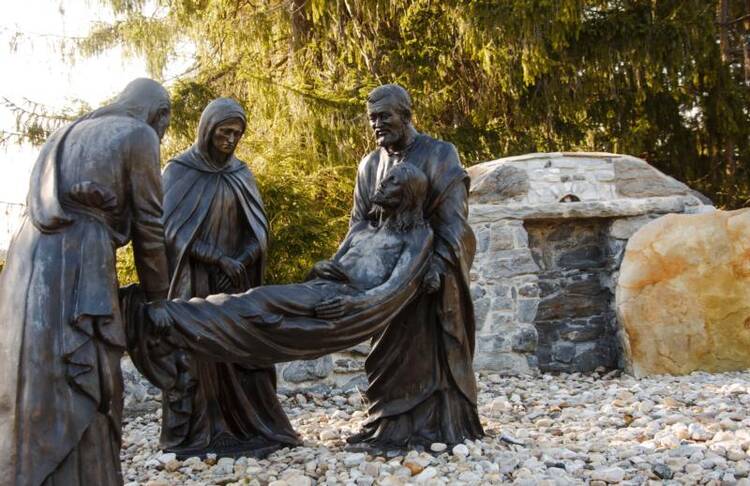 A life-size depiction of Jesus being laid in the tomb is seen on April 9 in the Stations of the Cross on the grounds of the National Shrine of the Divine Mercy in Stockbridge, Mass. (CNS photo/Octavio Duran)