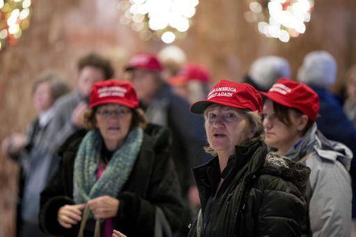 Visitors to the lobby of Trump Tower wear "Make America Great Again" hats, Monday, Dec. 5, 2016, in New York (AP Photo/Andrew Harnik).