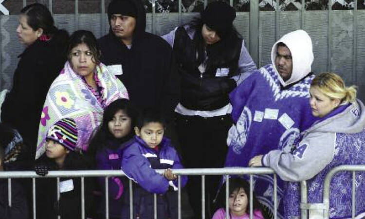 Redistributing Wealth?Families wait in line for the Los Angeles Mission's Christmas meal service. 