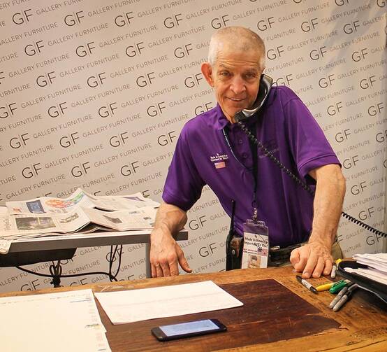 Jim “Mattress Mack” McIngvale answers the telephone at his original Gallery Furniture store in Houston on Sept. 2, 2017. McIngvale, motivated by his Catholic faith, dispatched trucks to rescue Harvey flooding victims and opened his stores as shelters to hundreds of evacuees and Texas Army National Guard troops. (RNS photo by Bobby Ross Jr.)