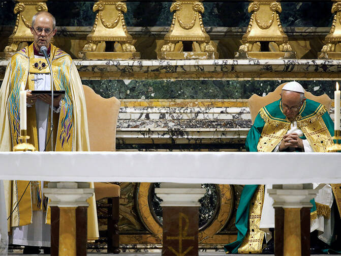 Archbishop of Canterbury Justin Welby, left, speaks, flanked by Pope Francis, during vespers prayers at the monastery church of San Gregorio al Celio in Rome, Italy, on Oct. 5, 2016. Photo courtesy of Reuters/Tony Gentile