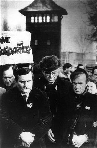 In this Jan. 17, 1988 file photo, Nobel Peace Prize winners Lech Walesa, left, and american Jewish writer Elie Wiesel, right, arrive at the former Auschwitz-Birkenau death camp in Poland. (AP Photo/Sokolowski, File)