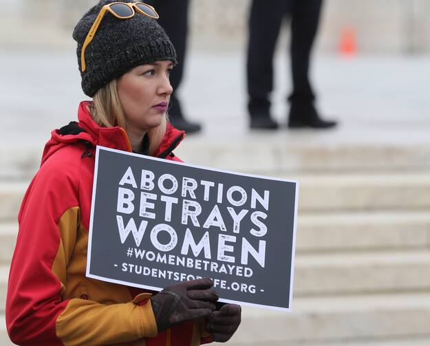 A young woman with Students for Life holds a sign outside the U.S. Supreme Court prior to the Women's March on Washington Jan. 21. (CNS photo/Bob Roller)