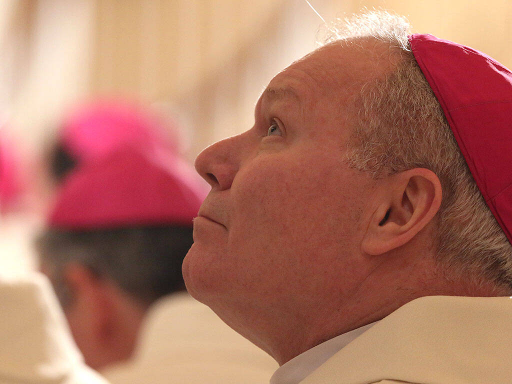 Bishop Edward J. Burns of Dallas looks up to the choir loft during Mass Nov. 12 at the Basilica of the National Shrine of the Assumption of the Blessed Virgin Mary in Baltimore on the eve of the fall general assembly of the U.S. Conference of Catholic Bishops. (CNS photo/Bob Roller)
