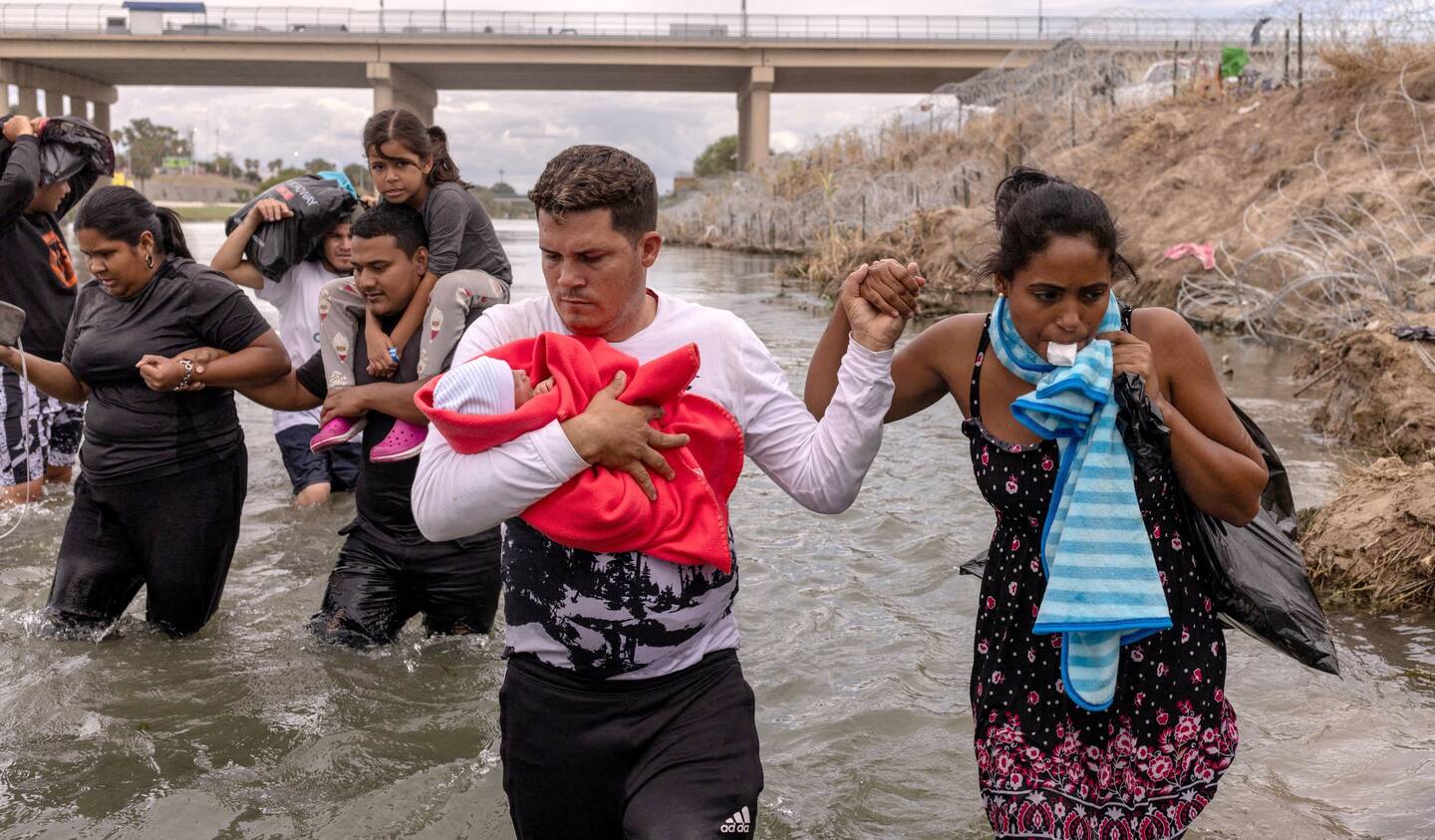 Yusniel, a migrant from Cuba, holds his 10-day-old son, Yireht, and wife, Yanara, along the banks of the Rio Grande after wading into the United States from Mexico at Eagle Pass, Texas, on Oct. 6, 2023 (OSV News photo/Adrees Latif, Reuters)