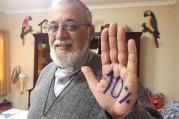 Camillian Father Mateo Bautista Garcia shows his hand with "10%" written on it. The priest wants Bolivia's government to spend 10 percent of its budget on health care. (CNS photo/David Agren)