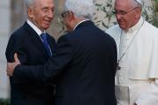 Pope Francis looks on as Israeli President Shimon Peres, left, and Palestinian President Mahmoud Abbas embrace at the Vatican. (CNS/Paul Haring)