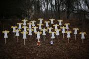 Twenty-seven wooden painted angels created by Eric Mueller are displayed outside his home in Newtown, Conn. (CNS photos/Mike Segar, Reuters). 