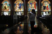 A woman prays during the Stations of the Cross on Holy Thursday at a church in Manila, Philippines, March 28. Holy Week marks a time of prayer and recalling the Passion of Jesus. (CNS photo/Cheryl Ravelo, Reuters) 
